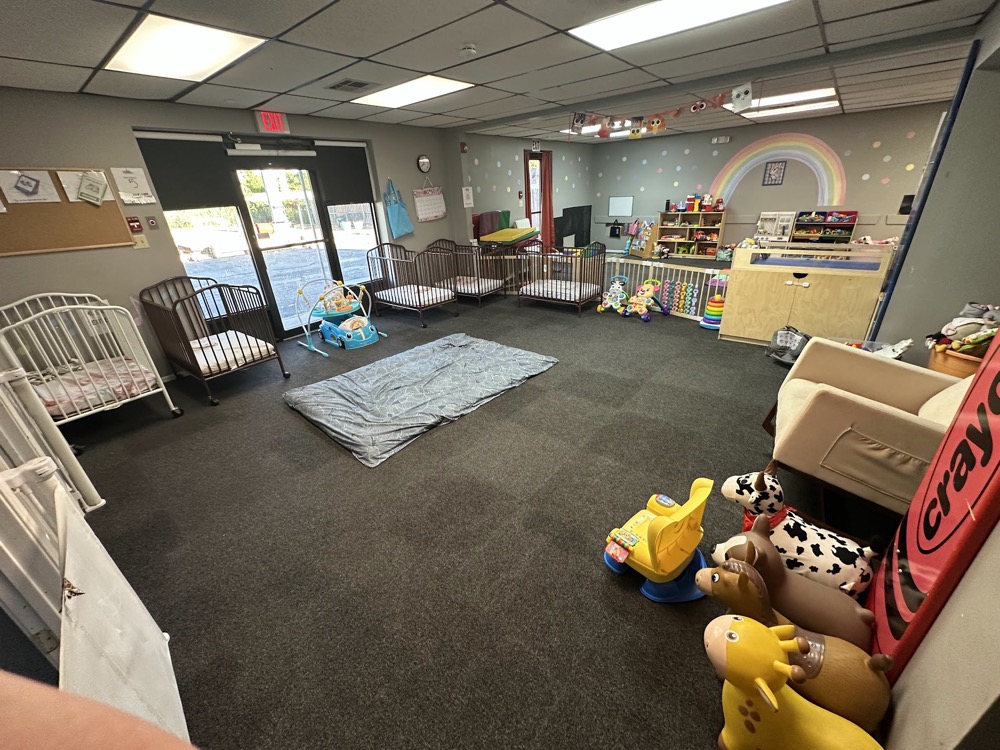 Infant room with cribs and soft play toys